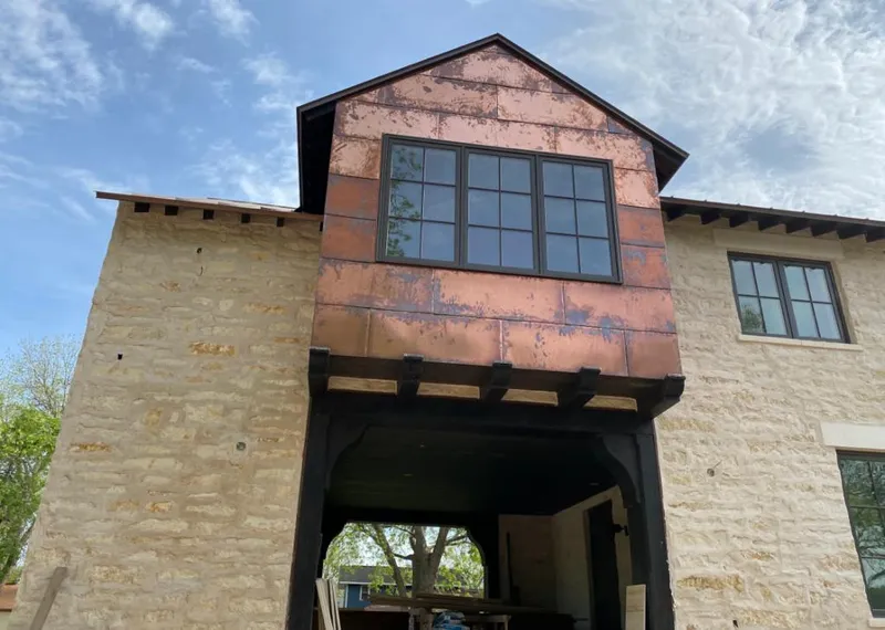 Copper metal panel facade on a stone building for Skylight Installation in Kissimmee